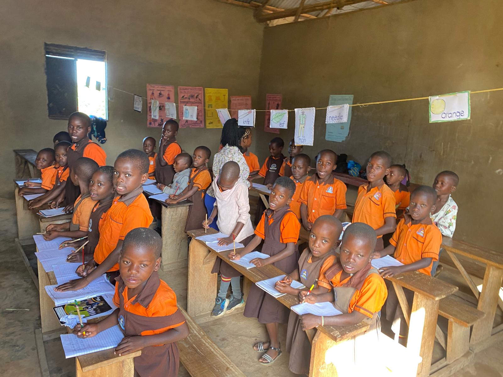 Children smiling and peeking through a school window