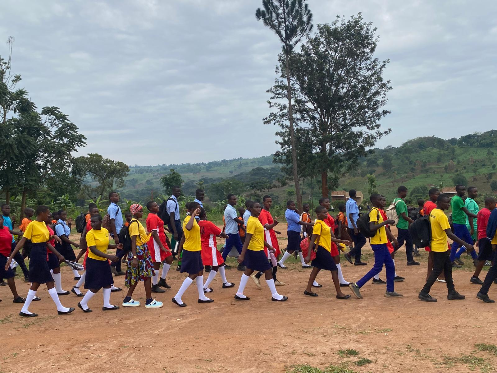 Young students in orange uniforms learning in a classroom at Mission Destiny School